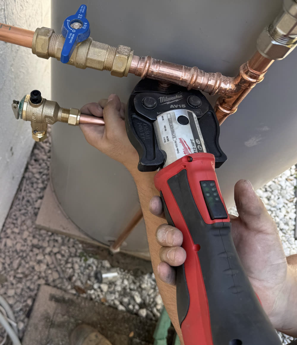 Press-fitting copper pipe on a hot water system